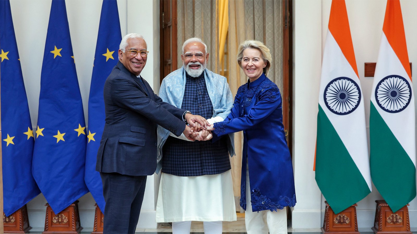 Leaders of the European Union and India announcing historic free trade agreement with flags of EU and India in background
